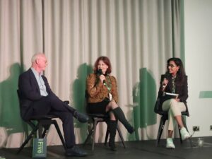 Three people in panel discussion on stage