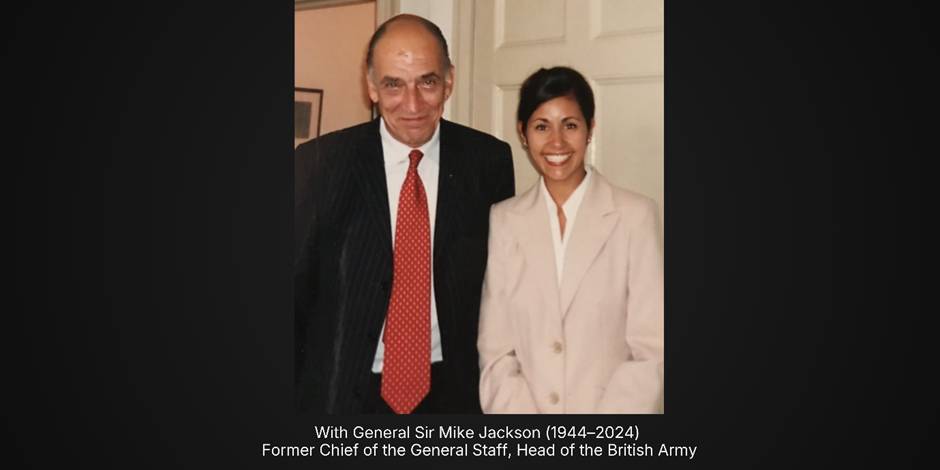 Two people in formal attire smiling indoors